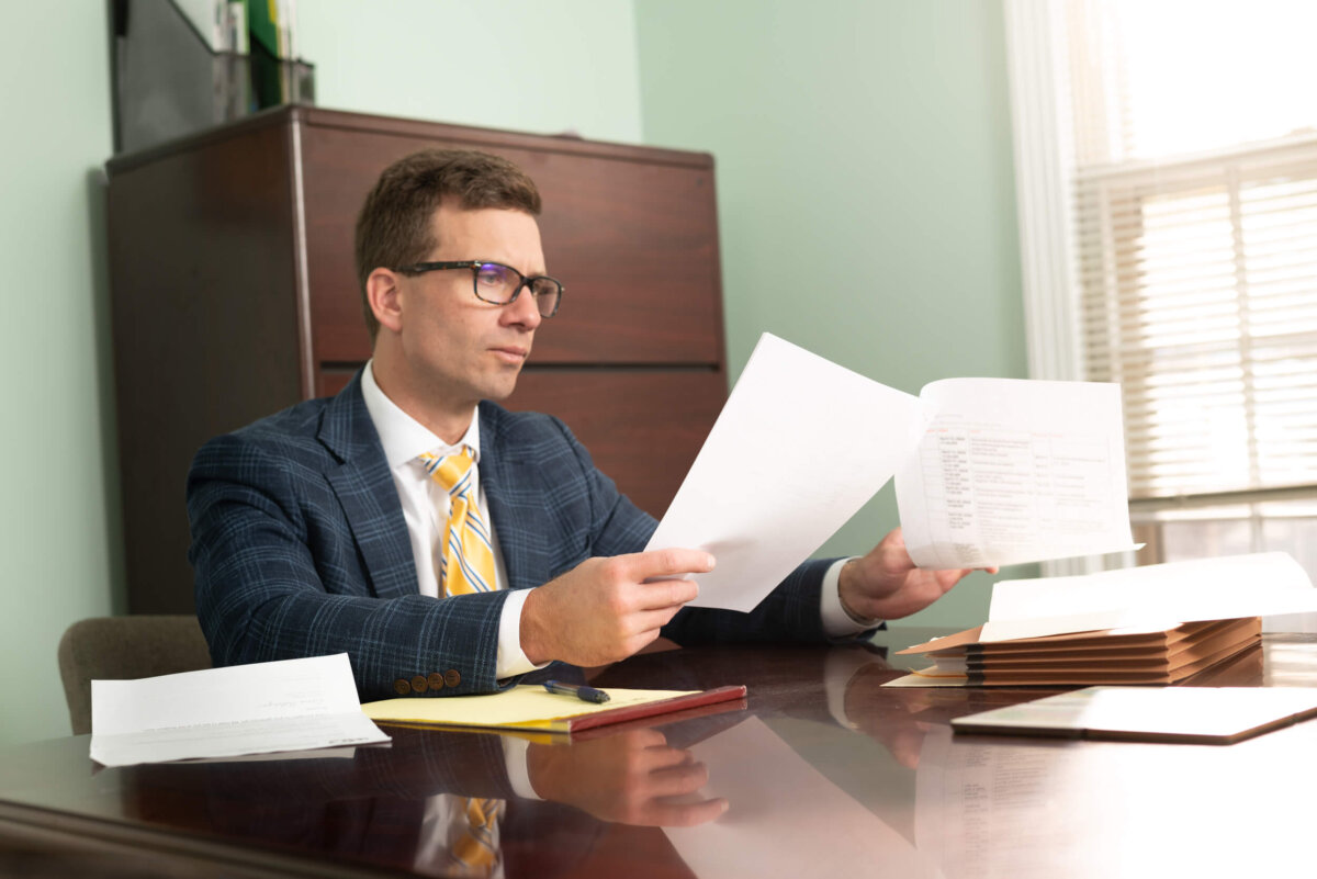 Attorney Landon White prepares to defend a client before the NC Board of Pharmacy